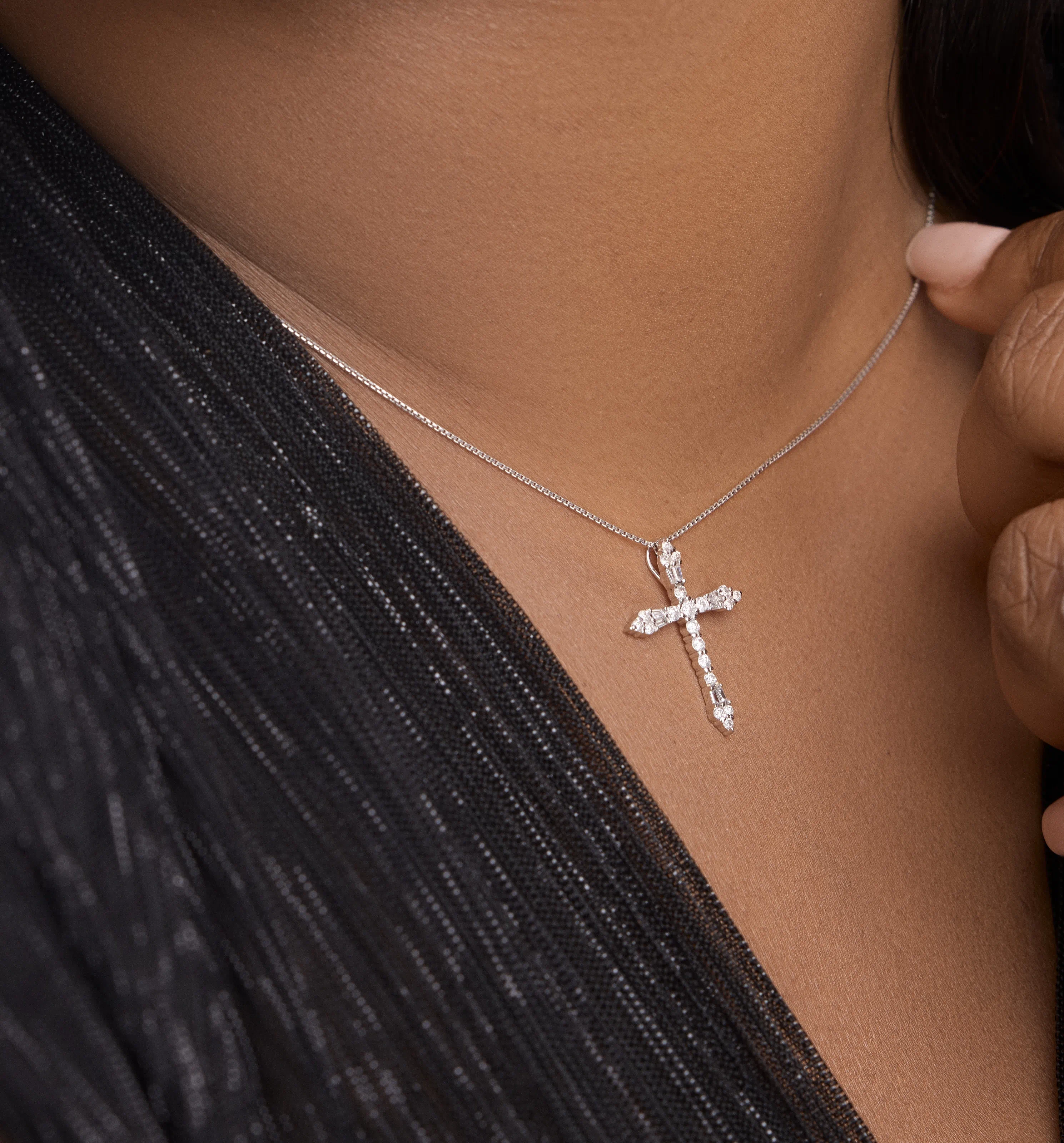 Side profile of delicate diamond cross pendant showing its slim design