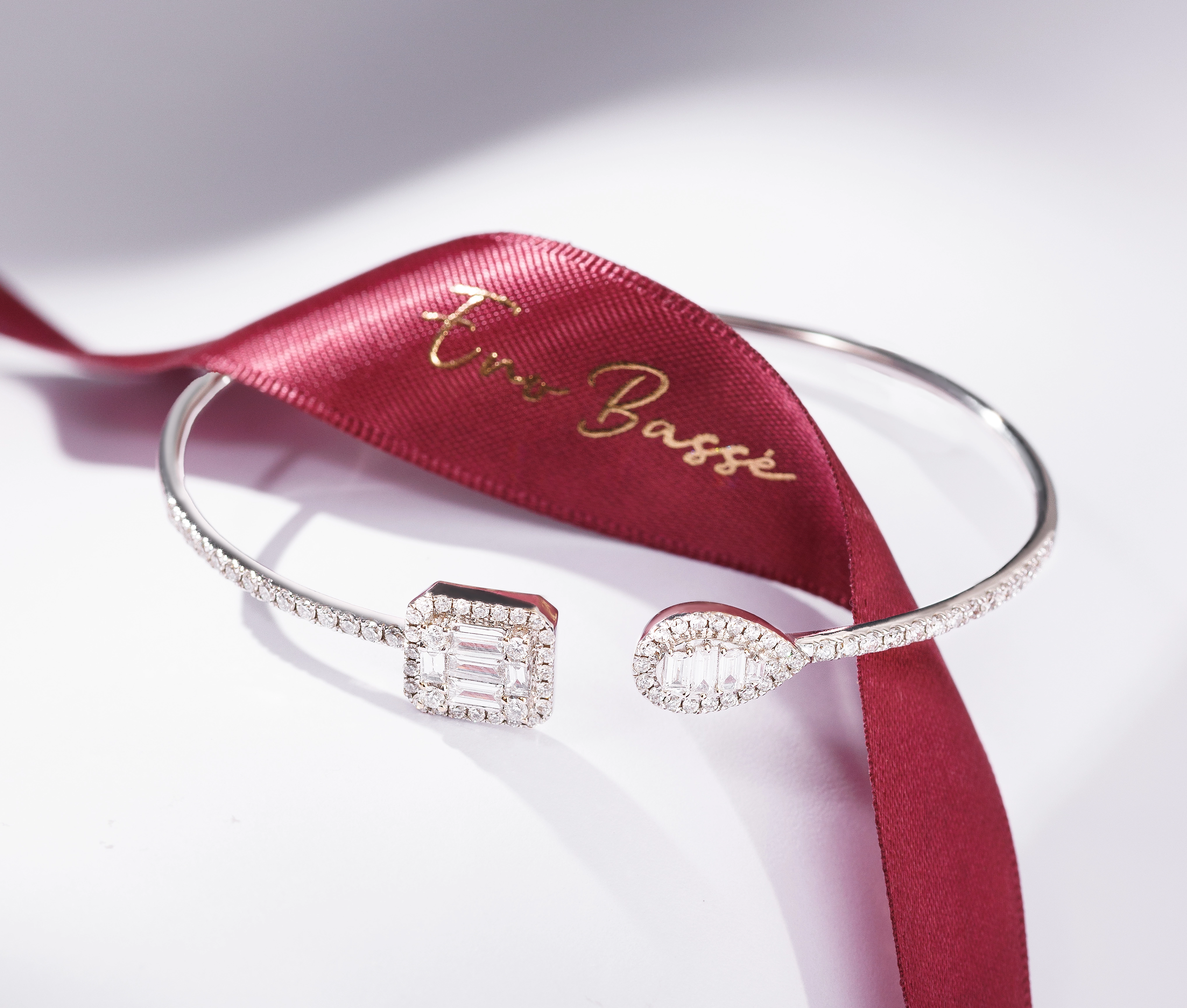 Side view of 18K White Gold Diamond Bangle highlighting alternating square and pear cut diamonds