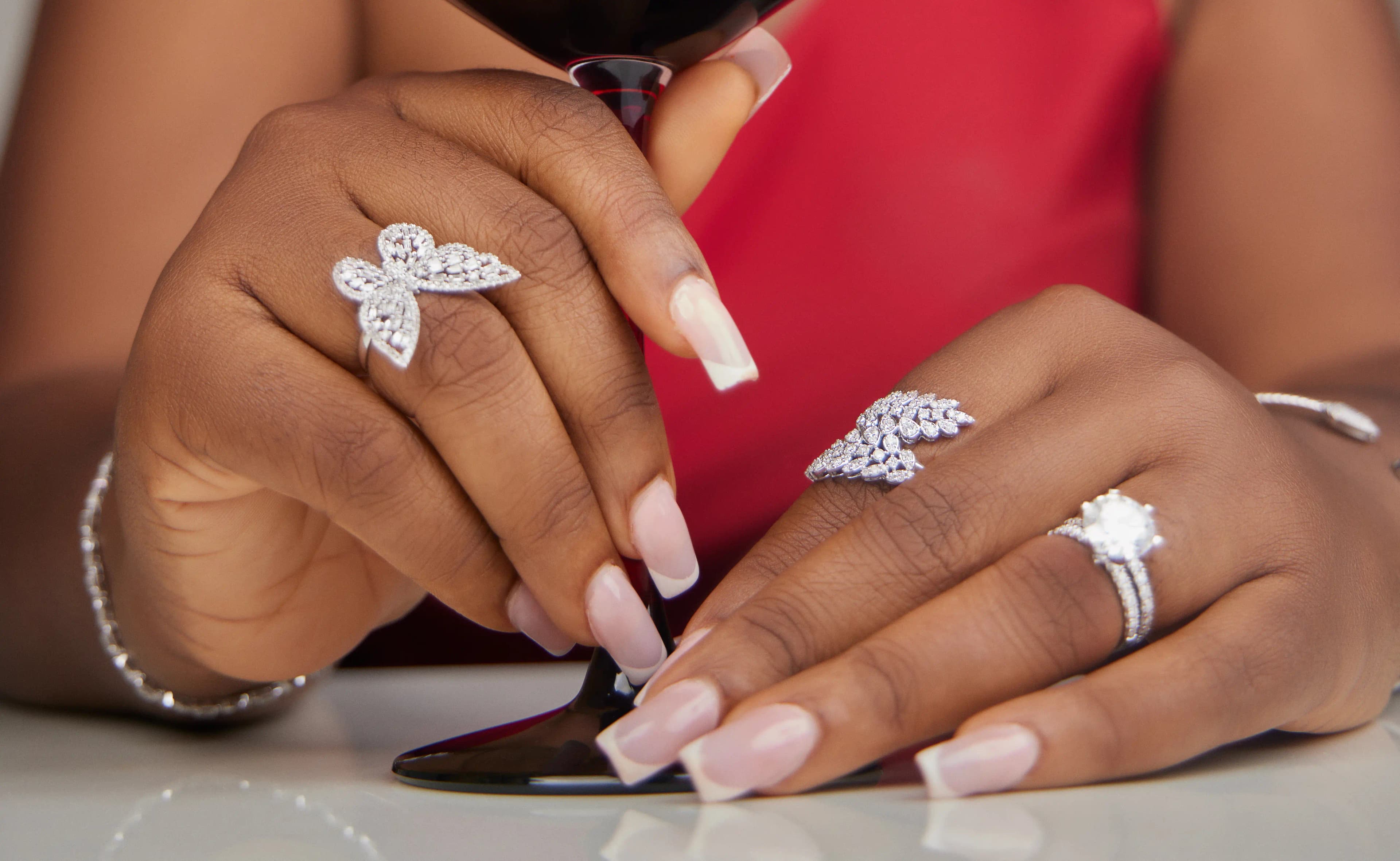 LAdy wearing three white gold  rings, bangle, and bracelet