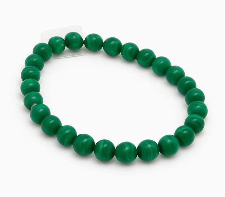 Green malachite bead with characteristic banded patterns