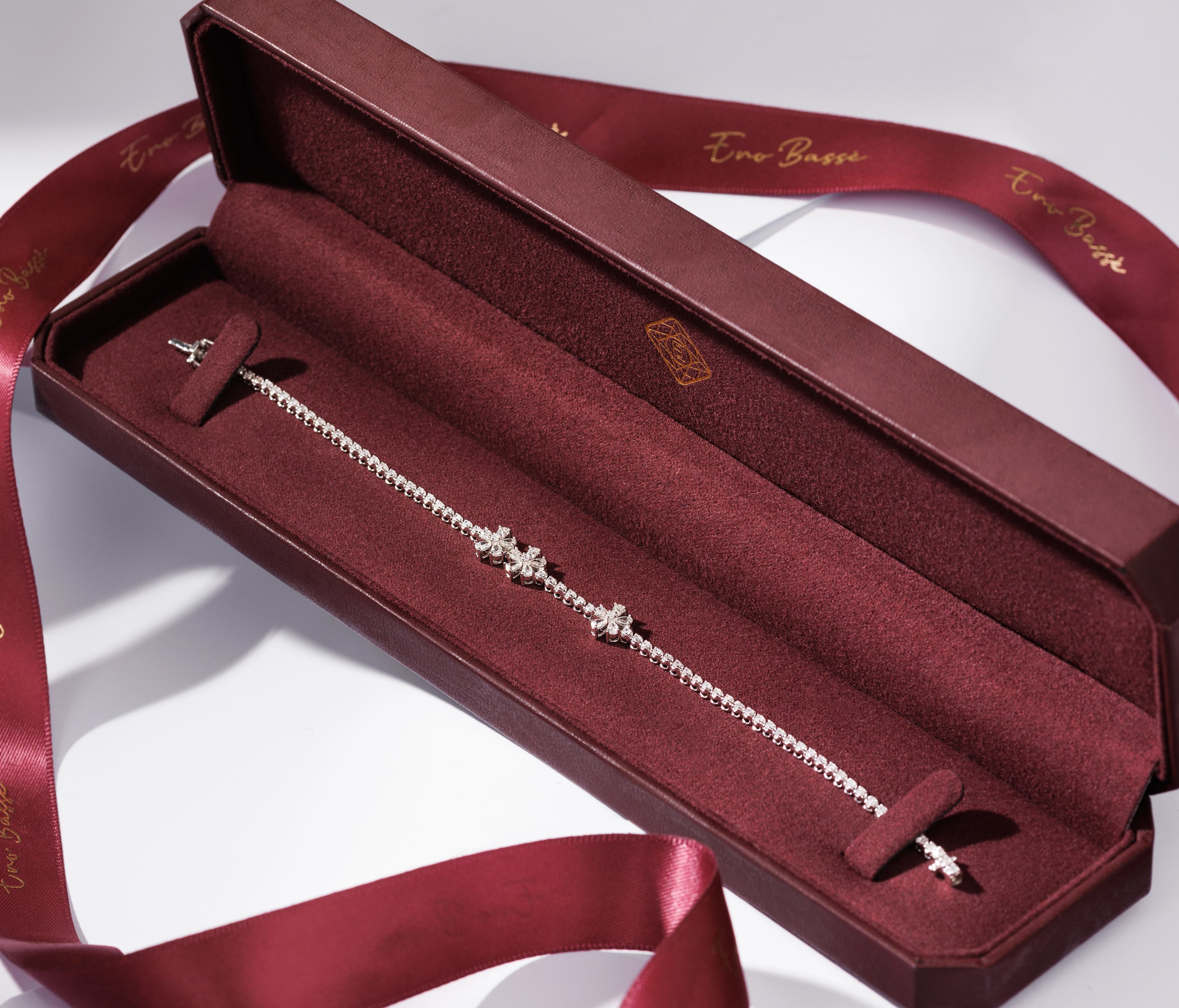 Diamond tennis bracelet with clove design motifs on white background